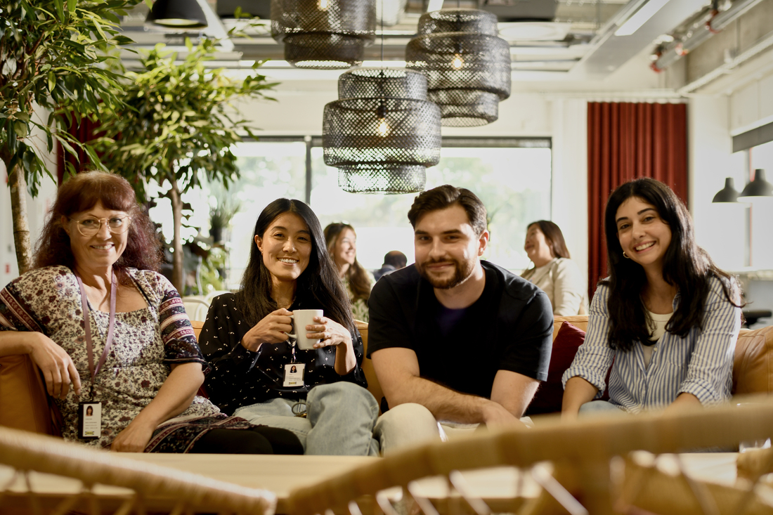 Group of four people listening to someone speak to them.